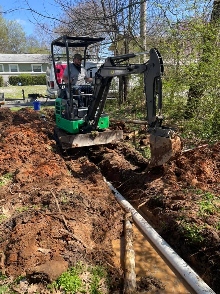 Excavation and underground pipe installation for residential plumbing repair.